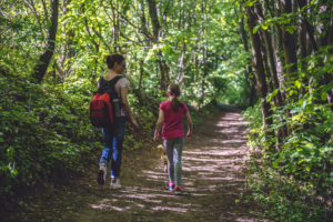 Mother and daughter walking in woods