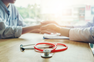 doctor holding hand with patient