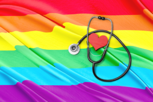LGBTQ flag and stethoscope