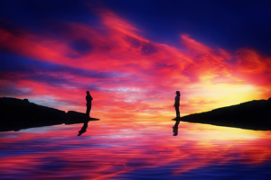 2 people on either side of a calm river