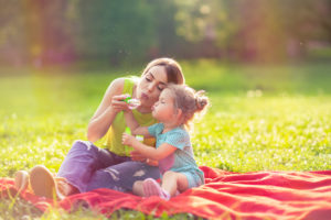 mother and daughter blowing bubbles