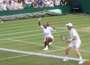 Serena Williams playing mixed doubles at Wimbledon, 2019. Public domain, Wikipedia. Photo by Brian Minkoff, London Pixels.