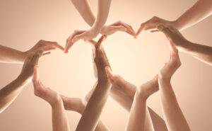 Symbol and shape of heart created from hands.The concept of unity, cooperation, partnership, teamwork and charity.