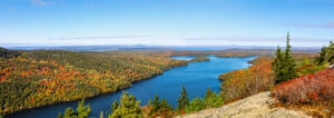Panoramic aerial view of the blue water and fall foliage