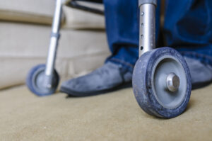Elderly man using a Rollator walking frame