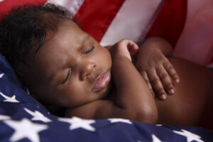 baby napping on American flag
