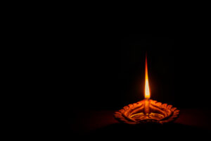 A traditional diya clay oil lamp lit at night on Diwali.