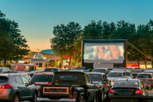Watching movies outdoors from the car in the city parking lot on a warm summer night