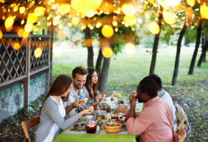 Group of young friends having traditional dinner on Thanksgiving Day