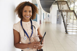 Portrait of young doctor with stethoscope, looking at camera