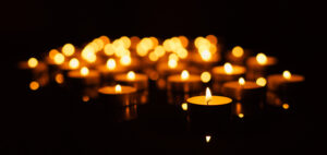 many small candles burning in the dark