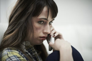 Female Victim Of Domestic Abuse Phoning Support Group
