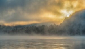 fog over a lake at sunrise