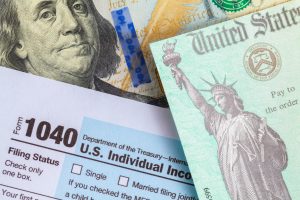 Tax form 1040 and a 100 dollar bill