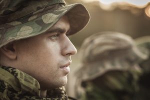 Close up of a young soldier wearing a military uniform