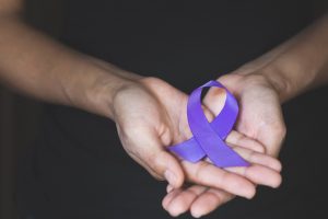 Woman Hand Holding Purple Ribbon