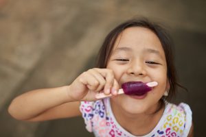 girl eating popsicle