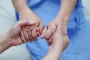 Holding Touching hands Asian senior or elderly old lady woman patient with love, care, helping, encourage and empathy at nursing hospital ward : healthy strong medical concept