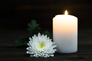 Burning candle and white Chrysanthemum flower