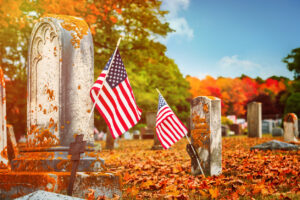 American veteran flags in autumn cemetery. Veterans Day concept.