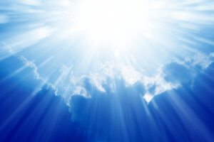 Peaceful background - beautiful blue sky with bright sun, light from heaven