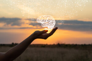 Hand shows the brain in the sun and sky.