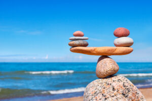 Concept of harmony and balance. Balance stones against the sea. Rock zen in the form of scales
