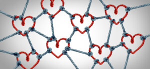Love network together and unity or loving partnership and concept of team and teamwork idea as a metaphor for joining diverse ropes connected together as a heart for cooperation and working collaboration.
