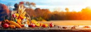 pumpkins and apples and corn on table