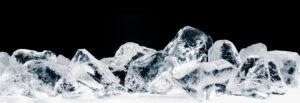 Pieces of crushed pure ice cubes on black background.