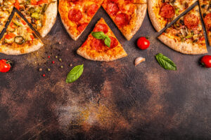 Set of different pizzas - pepperoni, vegetarian, chicken with vegetables, top view