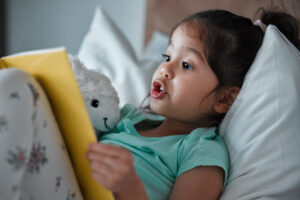 girl reading in bed