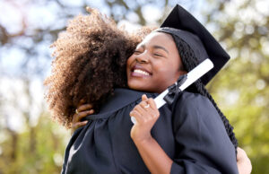 2 college graduates hugging