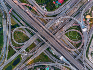 High angle looking top down view of complicate road and expressway intersection in Bangkok city of Thailand. Shot by drone can use for transportation or abstract concept.