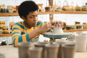 handcraft artist person using art skill of creativity to making ceramic clay craft pottery workshop by hand finger, wet and dirty work with mud for shape bowl traditional in hobby or manufacturing