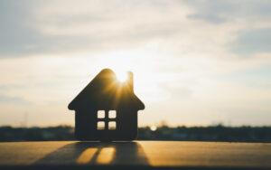 Wooden house model on wood background, a symbol for construction , ecology, loan, mortgage, property or home.