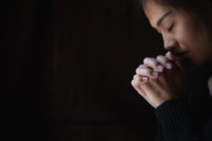 Christian woman praying worship. Hands folded in prayer, worship god.