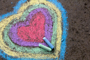 chalk drawing: colorful hearts on asphalt