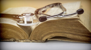  Stethoscope on an old book of medicine, conceptual image