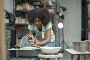 Watch in awe as an African American boy unleashes his craftsmanship, delving into the art of clay handwork, forging a path of artistic pursuit in the ceramic studio.