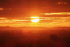 Los Angeles fiery morning sun bursting through clouds and fog above the San Fernando Valley.