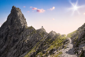 One Single Mountain Biker Riding to the Summit