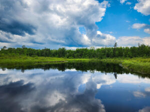 The sky reflecting off of a perfectly still Lake in the boundary waters, northern Minnesota.