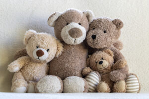 Happy teddy bear family (parents and two children) portrait