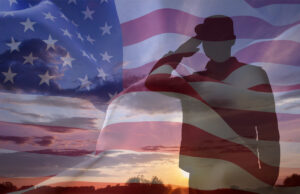 Silhouette of a soldier with USA flag against the sunset