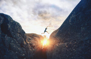 Man Jumping Against Sky During Sunset