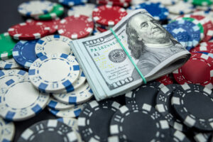Poker chips and dollar bills on casino table. Gambling. poker as a game of professionals. responsibility for games