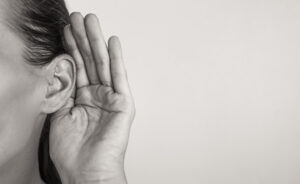 Girl listening with hand on ear