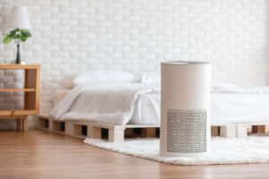 Air purifier in cozy white bed room for filter and cleaning removing dust PM2.5 HEPA in home,for fresh air and healthy life,Air Pollution Concept