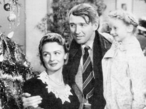 Jimmy Stewart, Donna Reed, and Karolyn Grimes in the American film It's a Wonderful Life (1946).